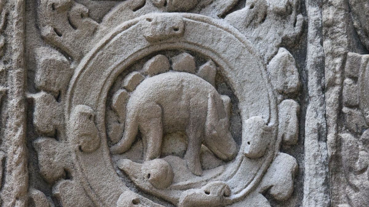 Stone roundel at Ta Prohm showing a four-legged animal with rounded shapes along its back
